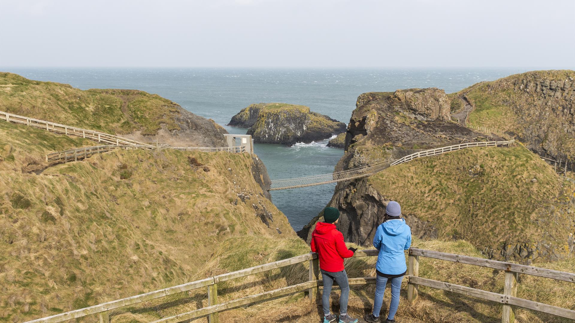 Two visitors admiring the views at Carrick-a-Rede