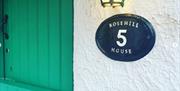 Sign for 'Rosehill House 5' beside green door