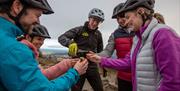 Cyclists enjoying ale refreshments from Whitewater Brewery on Bike Mourne Trails & Ails Tour.
