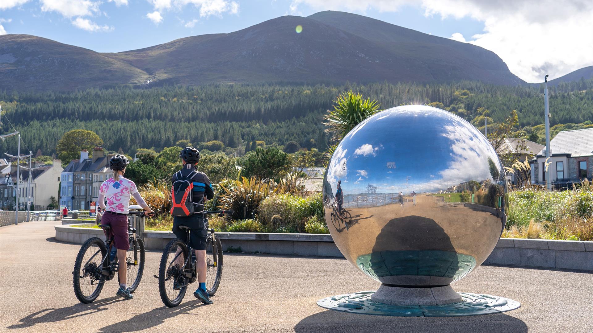 Cyclists on bikes from Bike Mourne, Newcastle admiring the Mourne Mountains from the Promenade, Newcastle, County Down