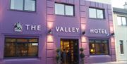 outside image of The Valley Hotel, with purple walls and black window frames and door