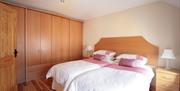 Two single beds and a wooden wardrobe