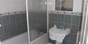 A grey and white tiled bathroom