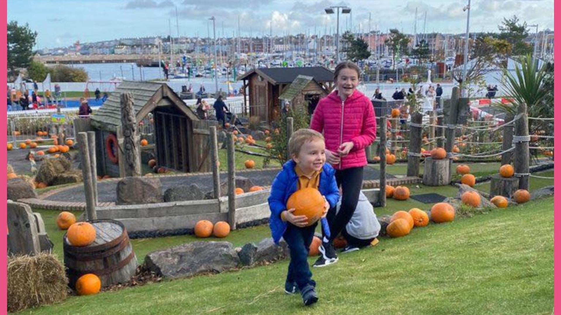 Kids enjoying picking pumpkins