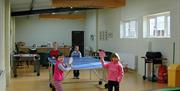 a photo of some kids playing table tennis