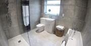 Photo of modern bathroom including bath and shower