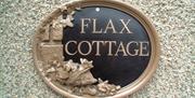 a photo of a sign saying flax cottage