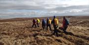 6 participants walking over the bog lands at Slieve Beagh Mountains as part of a guided walk