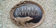 a photo of a sign saying clover cottage