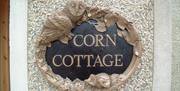 a photo of a sign saying corn cottage