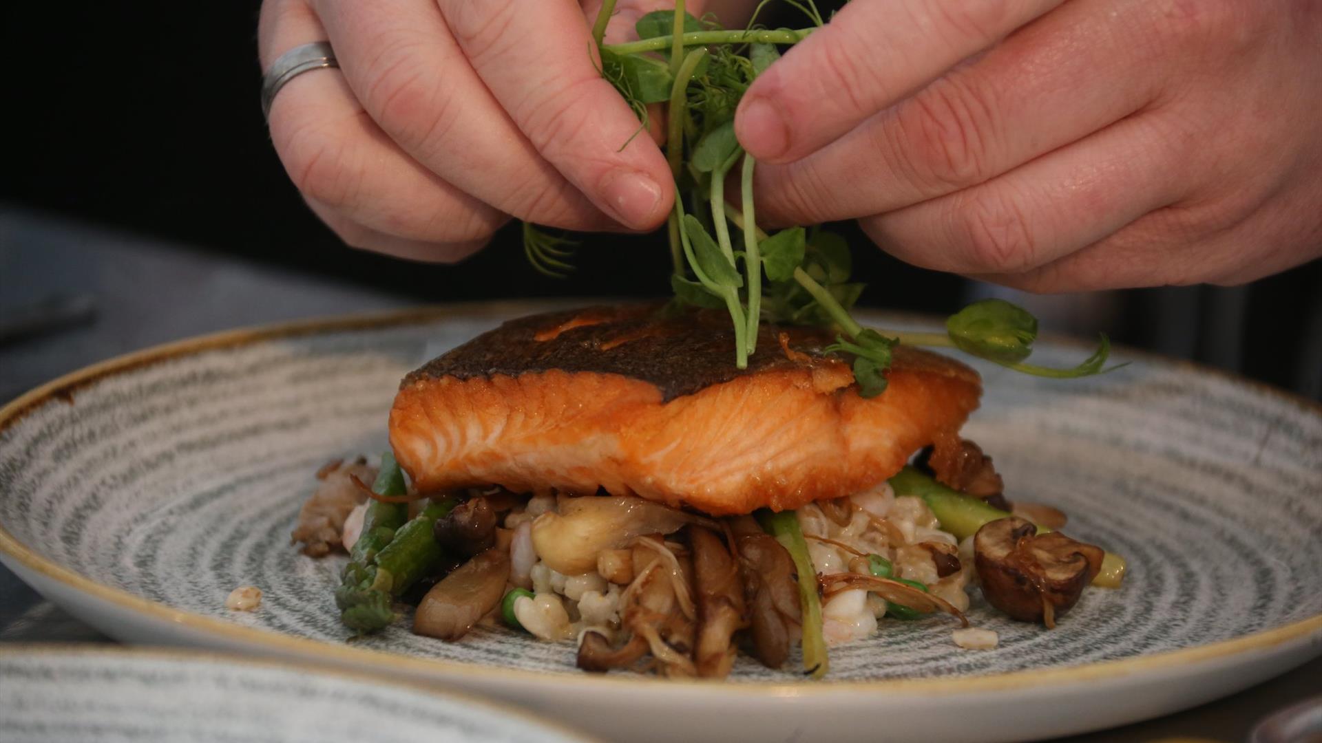 a close up of a salmon dish being prepared