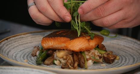 a close up of a salmon dish being prepared