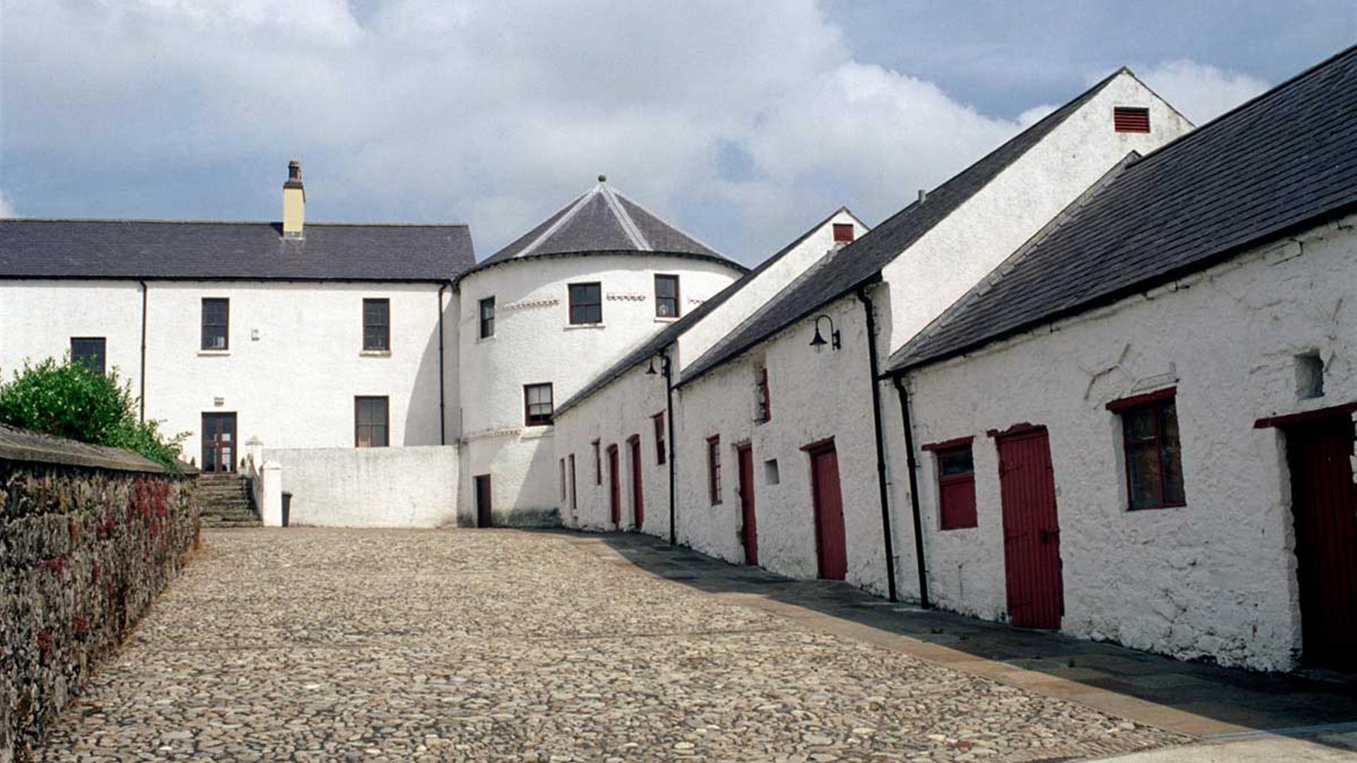 Image of white buildings lining a stone laneway