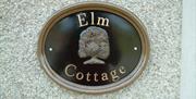 a photo of a sign saying elm cottage