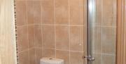 tiled bathroom with toilet in image