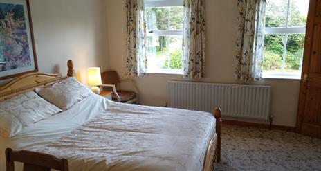 Double bedroom with radiator and 2 windows