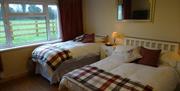 Triple room with 1 double bed and 1 single bed with bedside locker