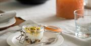 Shows image of breakfast table with granola and yoghurt