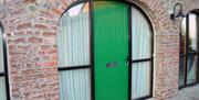 A green door in a arch way