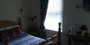 An image of a double bed and a window