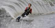 Image is of a man water-skiing