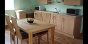 Kitchen and dining area with table and 4 chairs