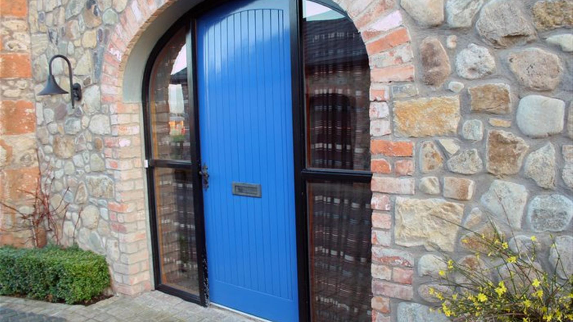 A bright blue door in an archway