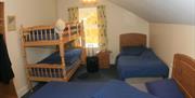 Multi sharing room with 2 single beds and single bunk beds