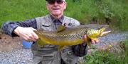 Genteman holding a large fish