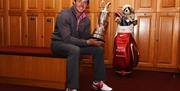 A photo of local golfing legend Rory McIlroy holding a trophy