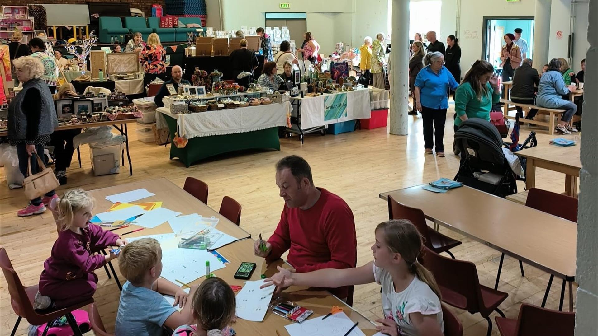 Hall filled with crafters and people undertaking activities