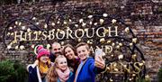 Family take a selfie at the Hillsborough Castle and Gardens sign