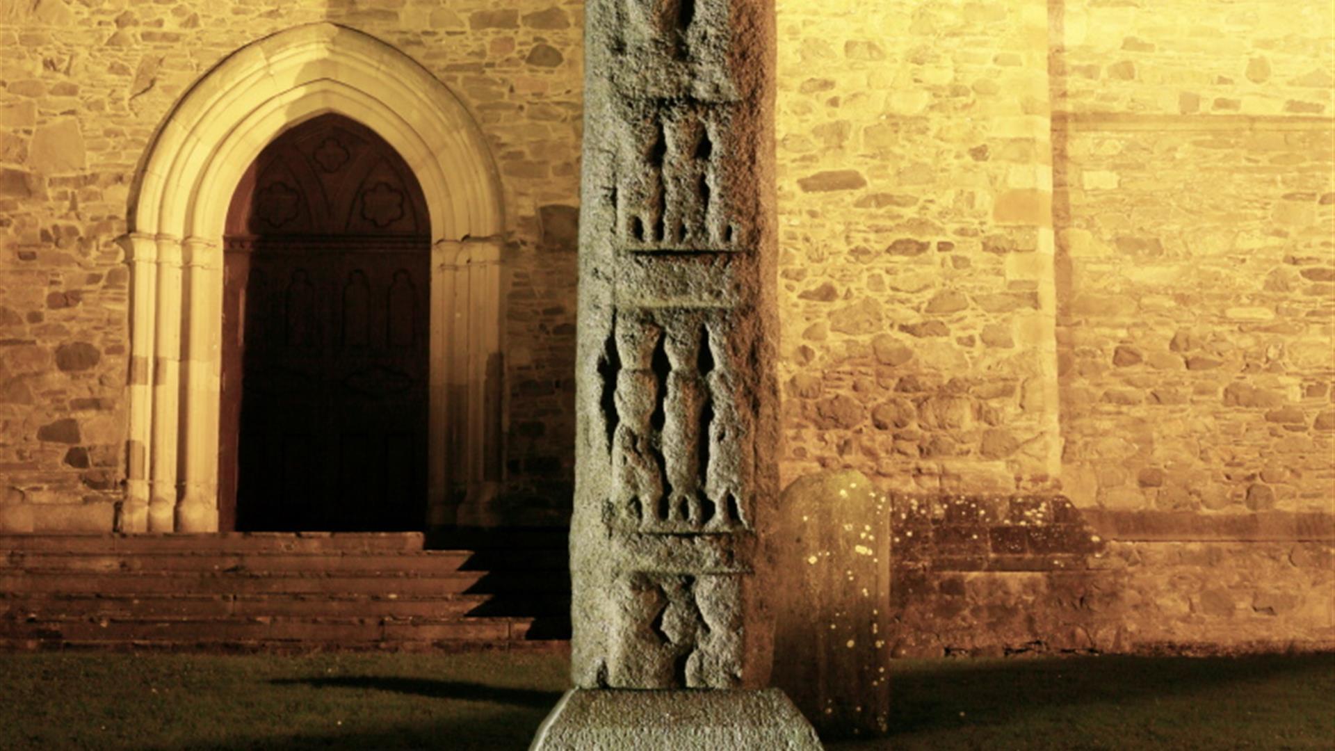 High Cross lit up at night outside Down Cathedral, Downpatrick