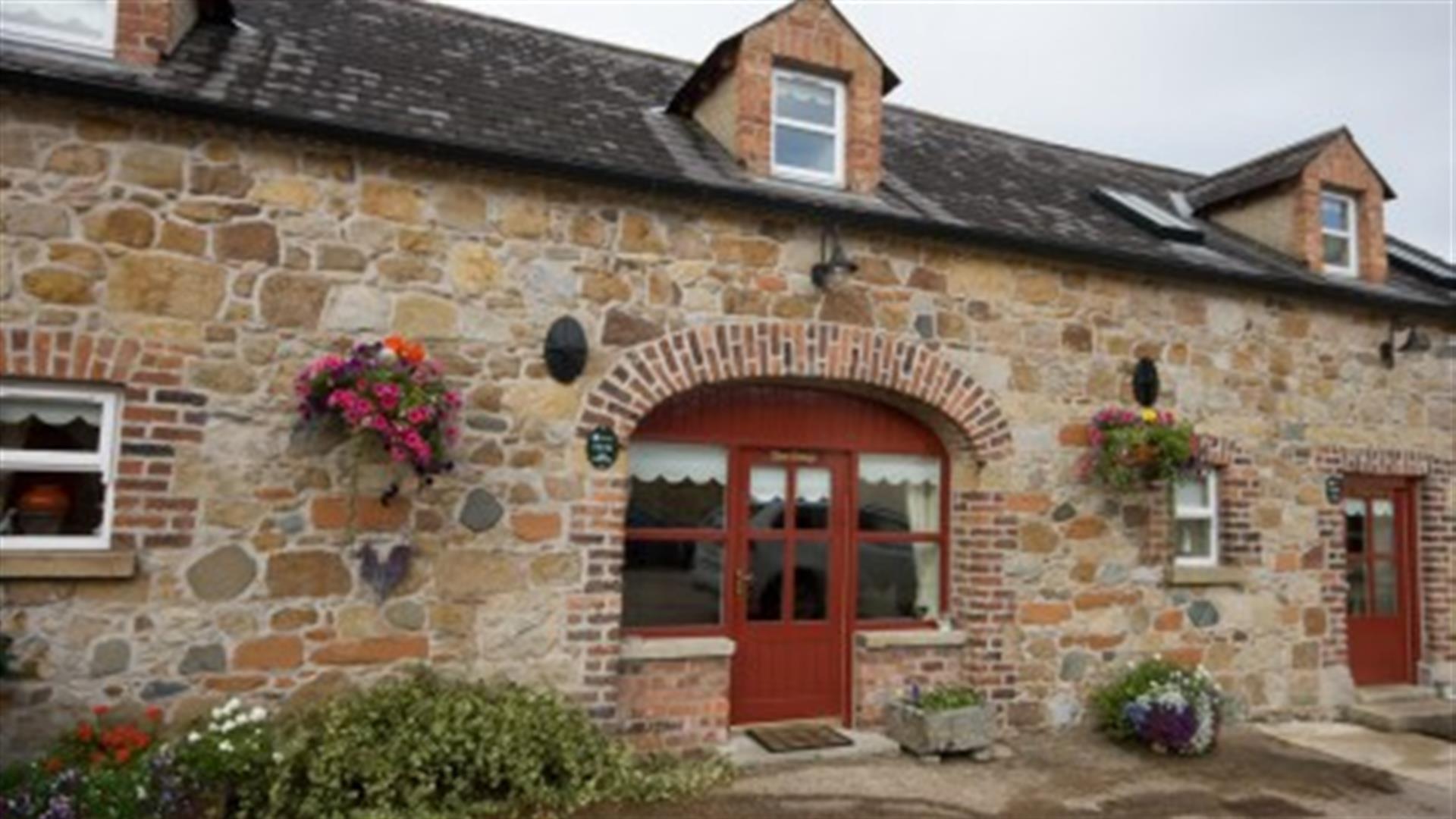 front door of cottage with stone walls