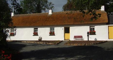 Outside image of cottage with yellow doors
