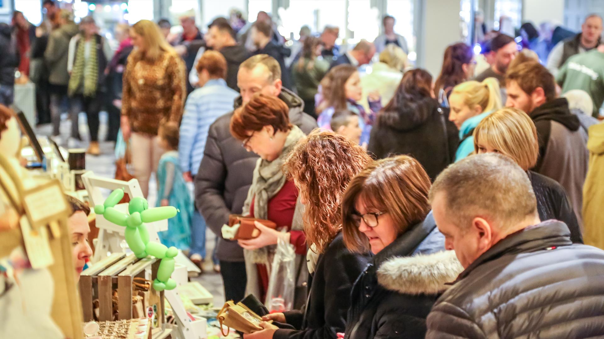 people browsing busy market stalls indoors people browsing busy market stalls indoors