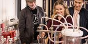 Tour group have a go at bottling gin at Belfast Artisan Distillery