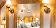 Double beds at the Brown Trout Country Inn are reflected in a mirror