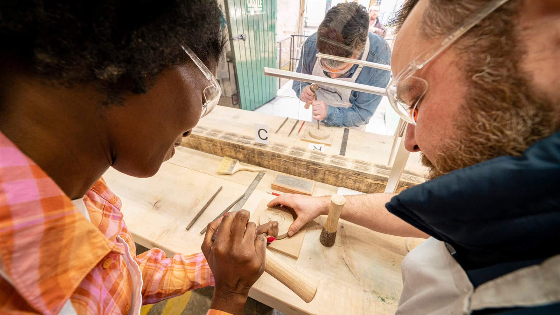 Learning to use the tools with Sam's help during the Carved at the Castle experience Learning to use the tools with Sam's help during the Carved at the Castle experience