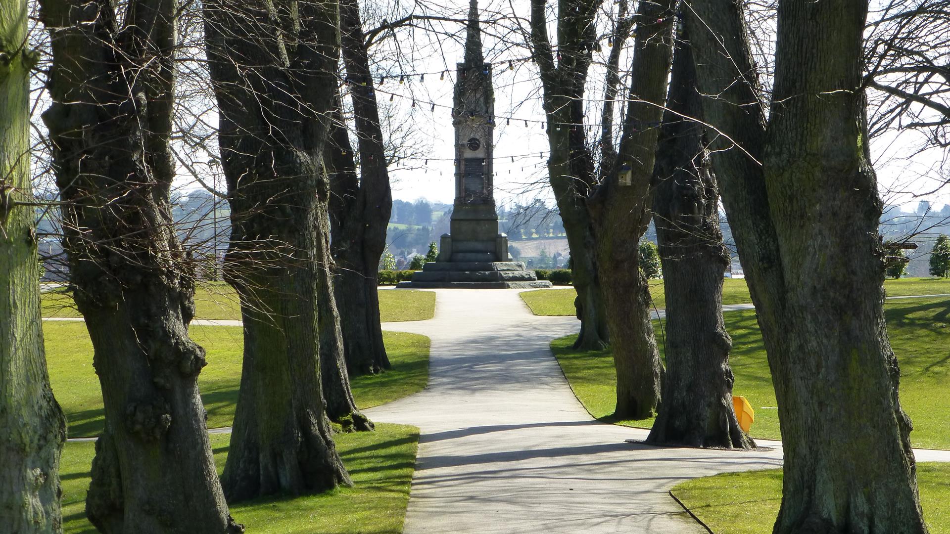 Tree lined avenue in Castle Gardens leading up to memorial