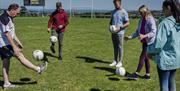 Group learns the basics of Gaelic football with DJ Kane