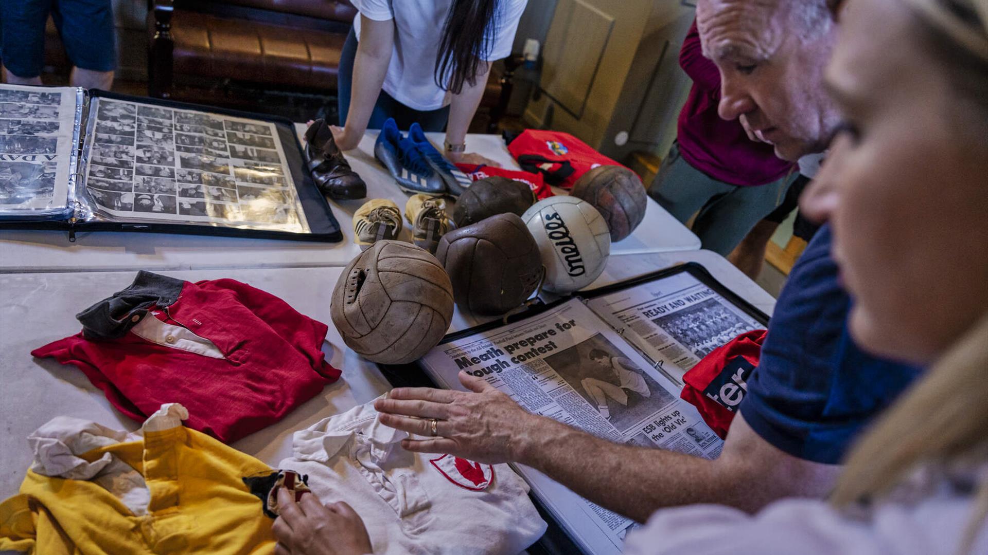 Guests examine Down GAA historical artefacts as part of the Gaelic Games and Craic experience Guests examine Down GAA historical artefacts as part of the Gaelic Games and Craic experience