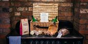 Image shows a hamper full of food and drink placed on an Aga in the kitchen