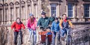 Steven from Hometown Tours guides a group of guests through custom house square towards the maritime mile as part of one of his Belfast bike tours.