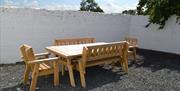 A picture of Picnic tables in a garden
