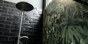 Shower with black tiled wall