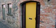 A yellow door into a house