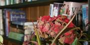 Bunch of flowers with bookcase behind