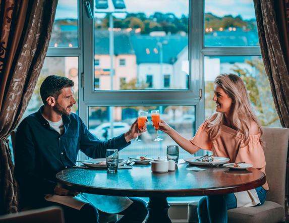 Couple enjoying food and drink at Canal Court Hotel over looking Newry Canal