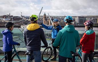 Group overlooking the Peace Bridge in Derry city on the Foodie Cycle Tour